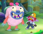 The transformed Sugar Sloth in front of a sprinkle miner Troll