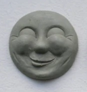 Resin cast of Thomas' unused jovial face