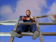 Junior riding on one of the windmill's sails