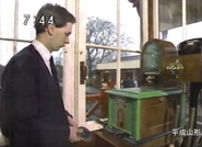 A signalman using the tablet to engage the Tyer's Electric Train Tablet instrument