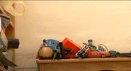 Thomas & Friends toys of Thomas, James, Percy and a Big Loader motor hidden behind other toys in the Numberjacks episode, "Out for the Count" (YouTube)[note 1]
