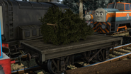 A short flatbed carrying a Christmas tree