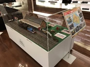 The green baggage transporter behind Crosby station at Hara Model Railway Museum