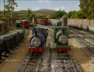 Sir Handel and Peter Sam passing a line of trucks