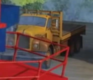 A yellow and orange flatbed lorry