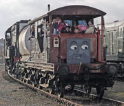 A brake van with a face at a  event.