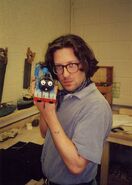 John Piper holding Gordon's model (Slate truck and fishing boat models in the background)