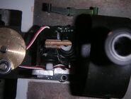 Whiff with two Futaba S3110 servos for his eye mechanism. One has damage to its casing, exposing the gears inside