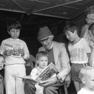 Wilbert reading Thomas Comes to Breakfast with a boy is holding a Ladybird book in around 1985