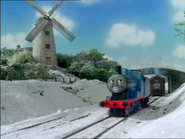 Edward and Toby passing by the windmill in the snow