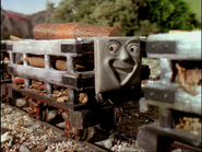 A slate truck with a square laughing face