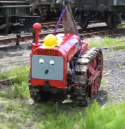 A crawler tractor with a face (and a construction helmet) at a Days Out with Thomas