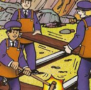 Workmen laying rails into the cave