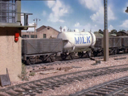 A milk tanker and a signalbox in the yard