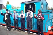 SamwithDriversFiremenandTFC.png (451 KB) Sam as Mr. Conductor with the Fat Controller, a Driver, a Fireman and a staff worker