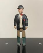 A small scale figurine of Farmer Collett prior to being sold by the Prop Gallery