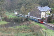 Muncaster Watermill, its basis (note that River Mite, Mike's basis and Douglas Ferreira are hauling a passenger train)