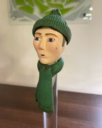 Another one of the Assistants' heads and green hat and scarf prior to being sold on Prop Gallery