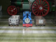 A narrow gauge truck with Sir Handel and a slate truck