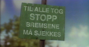 Pin Down Brakes sign translated into Norwegian