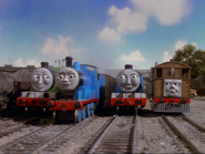 Henry and Gordon teasing Edward after some cows had broken his train and a indigned Toby trying to console Edward