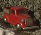 The newer red pickup truck