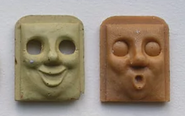 Resin casts of Bertie's laughing and shocked faces