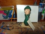 The Assistants' head and green hat and scarf as owned by Twitter User Thomas Wooden Railway Models