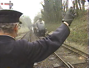 The stationmaster waiting for the key-token from the driver in Hello Thomas and James