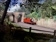 Rail Under Road Bridge and Stone Wall