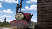 Peter Sam's driver putting water into Skarloey's funnel