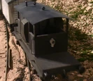 A dark grey brake van