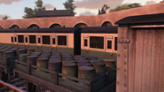 Some stakebed wagons loaded with oil drums