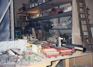 The farm windmill from Trapped on the middle shelf and one of the ÖBB boxcars on standby with various other rolling stock in a behind the scenes photo of the third series of Thomas & Friends.