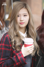 Sana holding a coffee