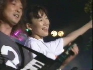 Kouda performing "Twin Memories" live in 1999.