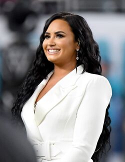 Demi Lovato Shoots Fabletics Commercial in Purple Workout Gear and Black  Sneakers