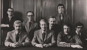 The Editorial Board of Playboy in 1970. Back, left to right: , Nat Lehrman, Richard M. Koff, Murray Fisher, Arthur Kretchmer; front: Sheldon Wax, Auguste Comte Spectorsky, Jack Kessie.