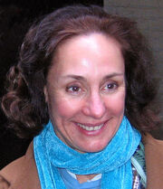 Metcalf smiling, wearing a coat and scarf