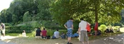 Players of  gathered around a "virtual" Pokémon gym in . Social interactions outside homes like this was one of the goals of Iwata's quality-of-life initiative.