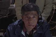 KCB staff member, played by Mitsuharu Kido (城戸 光晴, Kido Mitsuharu).