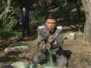 Kaji looking at the sandy remains of the Rahakam Stone