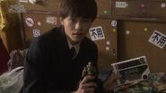 Tomoya showing his Jean Nine Spark Doll and his Gunpad.
