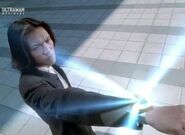 Fujimiya activates the Agulater, the two blades split and blue light is radiated off from the device.