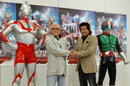 Susumu Kurobe and Hiroshi Fujioka shaking hands at the 2011 Blu-ray release of Ultraman vs. Kamen Rider