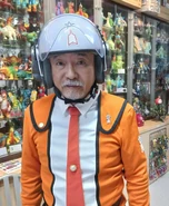 Akihide Tsuzawa reprising the role of Hoshino, photographed in 2023.[2]