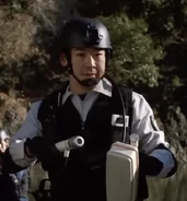 A member of the monster egg processing team, he is played by Sei Watanabe (渡辺 聖, Watanabe Sei).