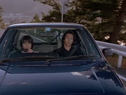 Fujimiya and Reiko escape Lizard's pursuit together.