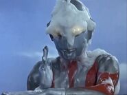 Ultraman coated with acidic foam of Aboras in the pose of Spacium Beam