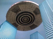 Robo-Fo flying over a city in its saucer form
